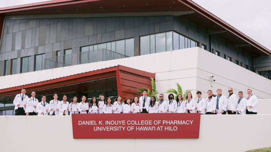 Newly inducted members of the DKICP Class of 2026 pose for a group photo in front of Hale Kihoʻihoʻi.