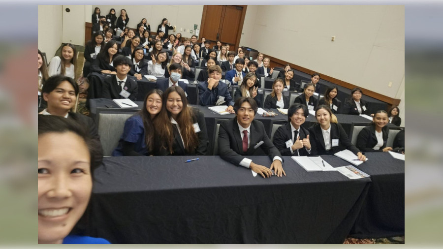 DKICP Associate Professor Cherie Chu takes a moment to pose with the audience of high school students after her presentation.