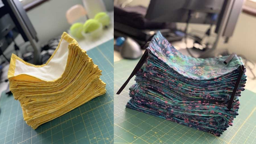 Stacks of yellow and cloth face masks sit on the assembly line.