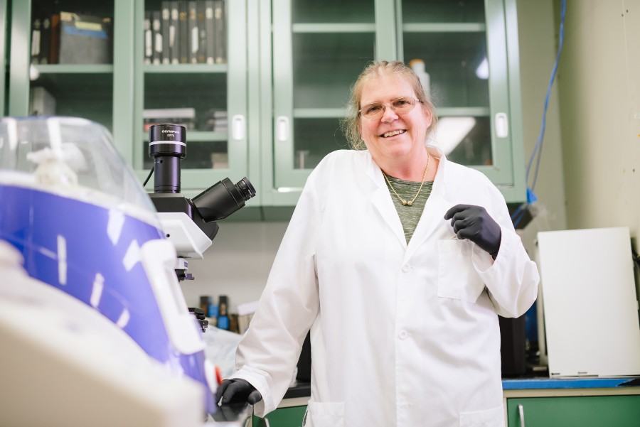 Dr. Sue Jarvi stands in a laboratory